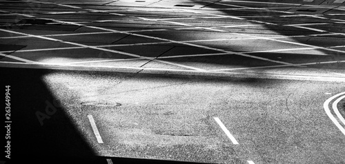 Black and white empty road with traffic lines in sunny day