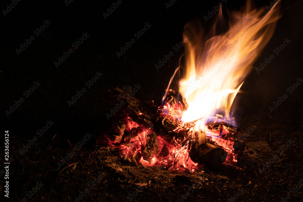 Fire on dark background.Fire Burning wood at night. Campfire of touristic camp in the mountains. Fire on dark background.Fire Burning wood at night. Campfire of touristic camp in the mountains.