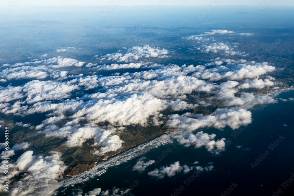 Flying above the clouds, view from the airplane, North Island, New Zealand Flying above the clouds, view from the airplane, North Island, New Zealand