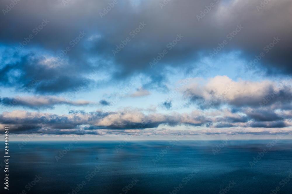 Sea and cloudy blue sky
