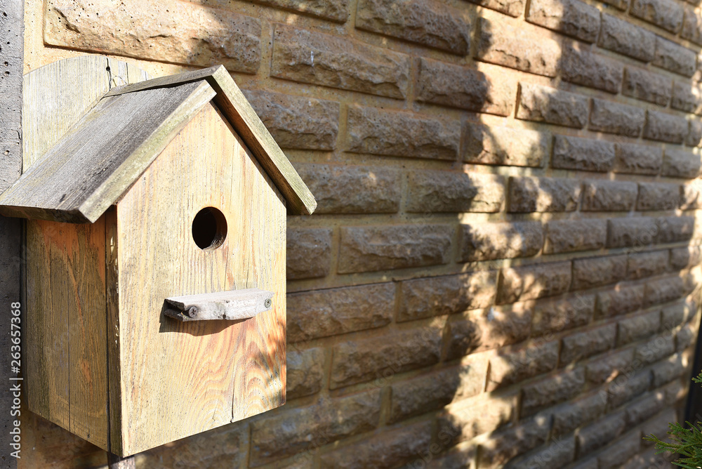 Closeup of a weathered birdhouse.