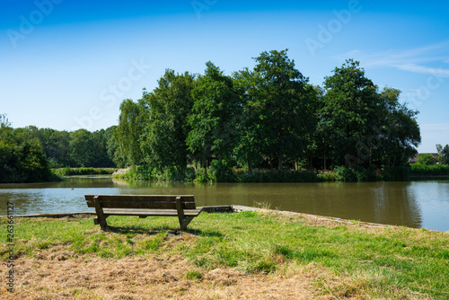 grass field and wooden bench in recreation park De Hulk, Hoorn, The Netherlands