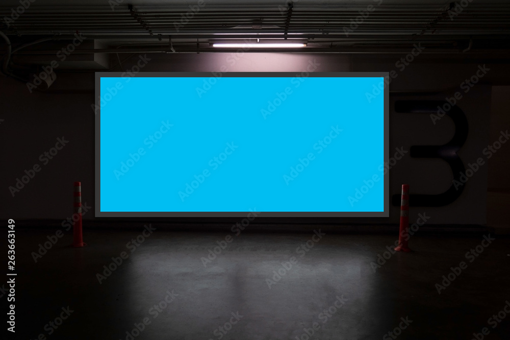 indoor car parking and empty blue billboard .Blank space for text and images. indoor car parking and empty blue billboard .Blank space for text and images.