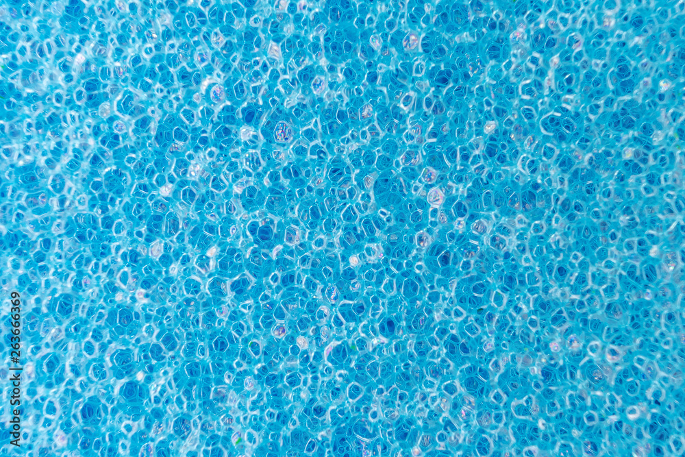 Blue porous sponge close up. Macro photo suitable as background.