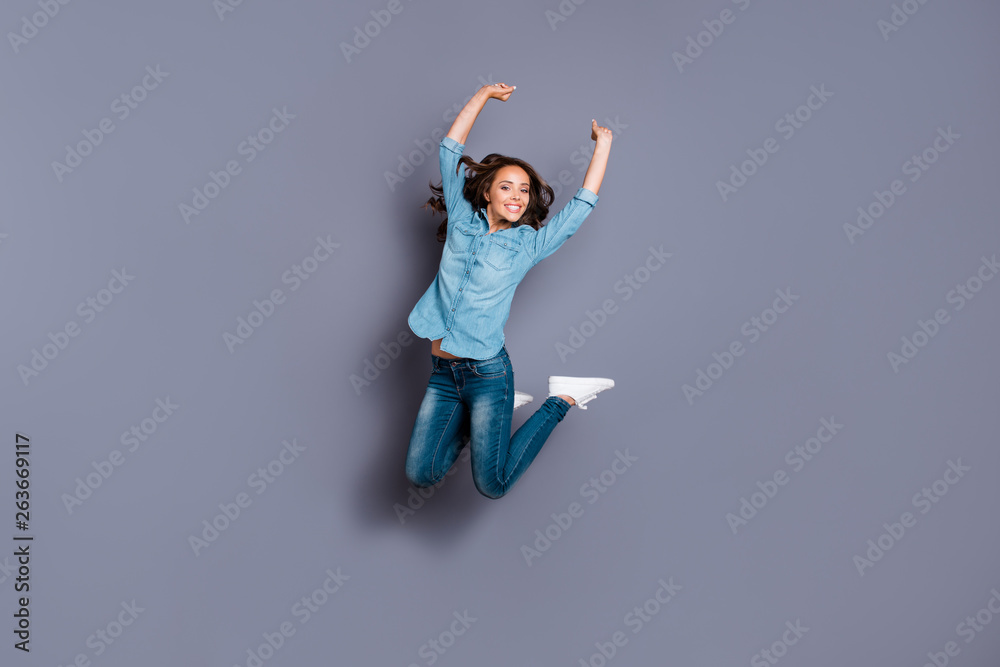 Full length body size photo amazing beautiful her she lady jumping high cheerleader glad basketball baseball football match fan wearing casual jeans denim shirt clothes isolated grey background Full length body size photo amazing beautiful her she lady jumping high cheerleader glad basketball baseball football match fan wearing casual jeans denim shirt clothes isolated grey background