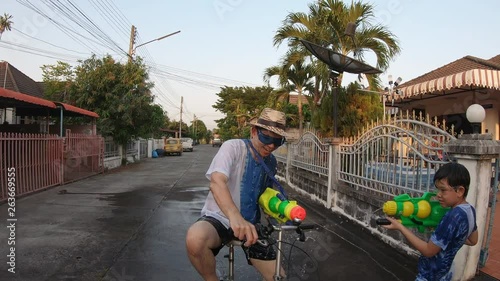 Slow motion people happy play splash water war celebration Songkran festival - local Chiang mai Thailand people in holiday traditional new year Songkran festival concept