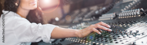 фотографія panoramic shot of sound producer working at mixing console