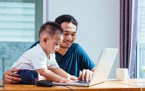 Man father working on laptop computer