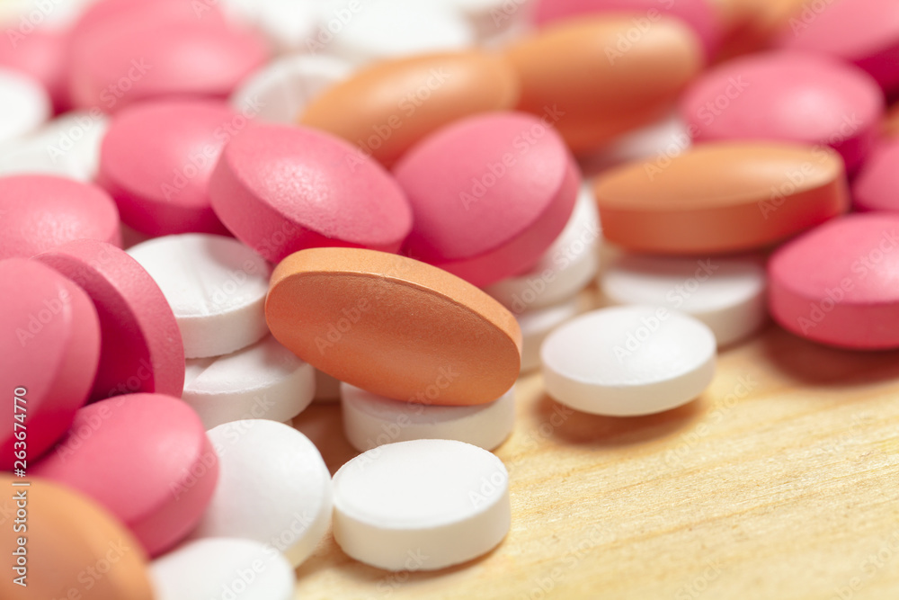 Assorted pharmaceutical medicine pills, tablets on wooden background Assorted pharmaceutical medicine pills, tablets on wooden background