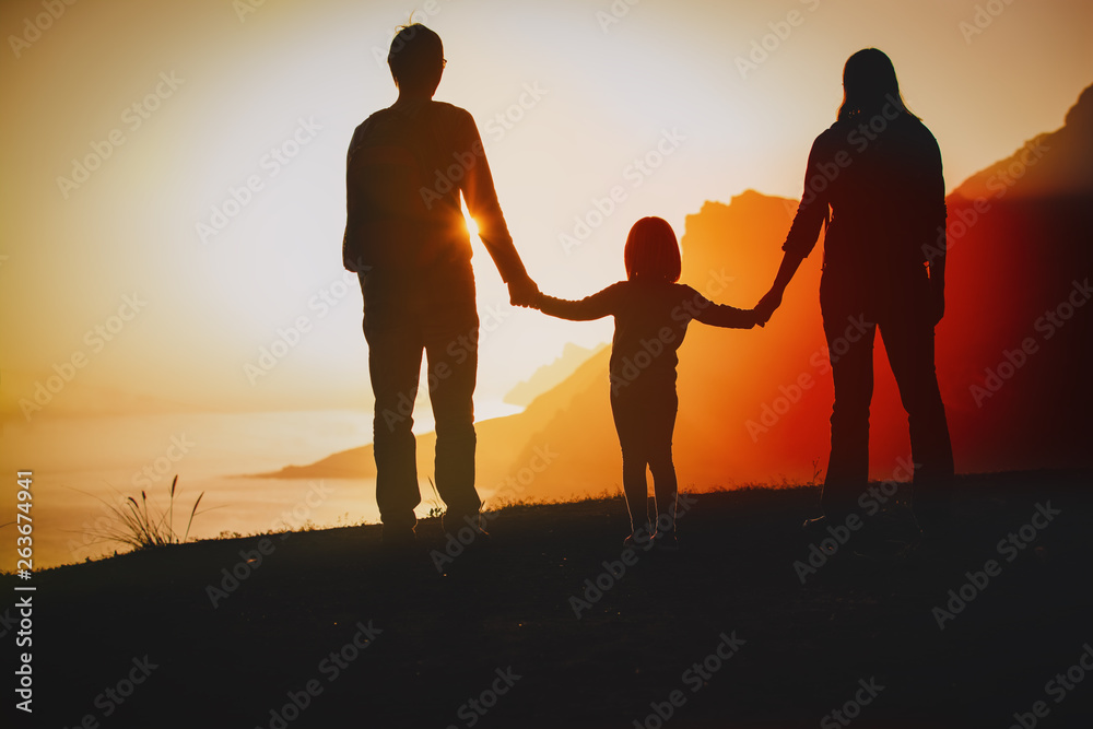 happy family-mom, dad and little daughter- travel at sunset