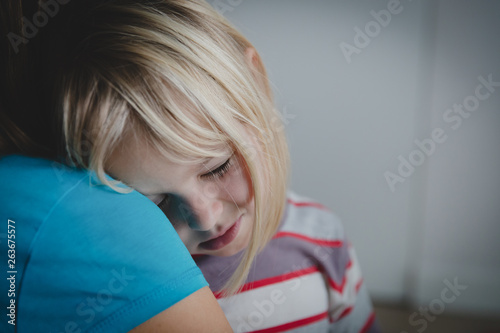 sad crying little girl hugging mother, parenting