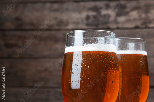 Beer glass against wooden background close up photo