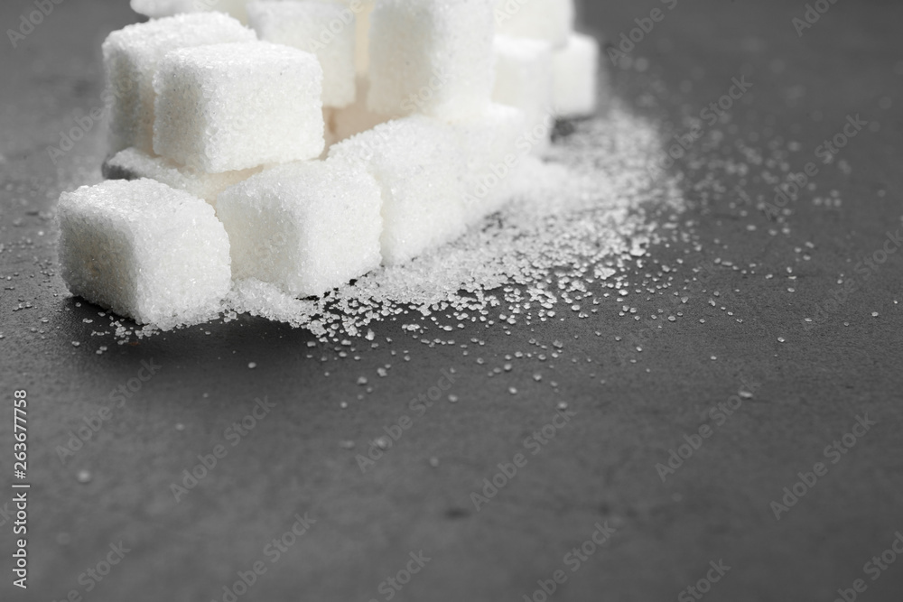 White sugar cubes over black background close up White sugar cubes over black background close up