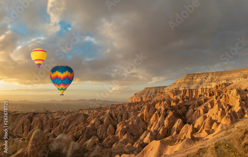 Panoramic view of geological rock formations and hot air balloons in Cappadocia Region, Turkey