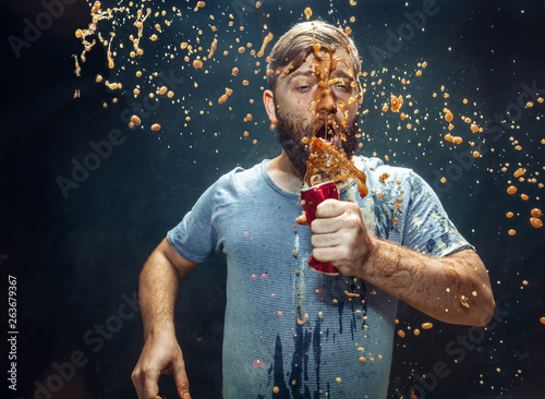 Man drinking a cola and enjoying the spray.