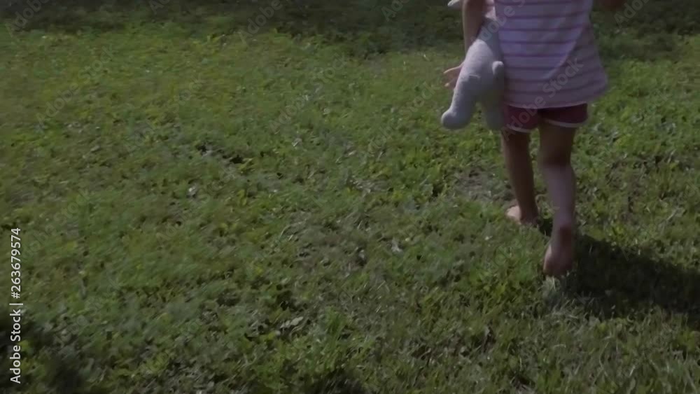 girly feet walking and running off on grass field in slow motion girly feet walking and running off on grass field in slow motion