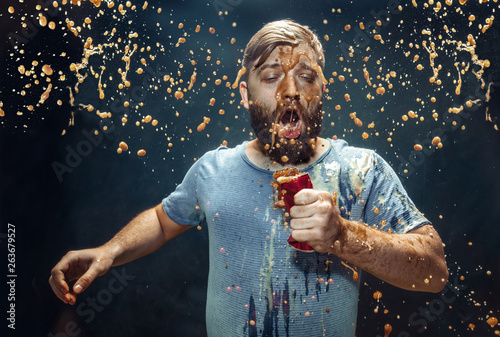 Man drinking a cola and enjoying the spray.