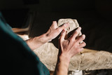 Close up of man works with clay. Male potter kneads and moistens the clay before work, toned