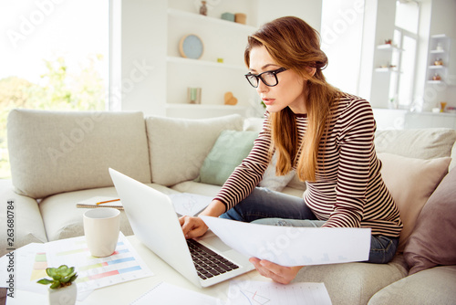 Close up photo beautiful she her model lady hands arms hold paper student test attentive search notebook wear jeans denim striped pullover clothes sit comfort cosy divan house living room indoors