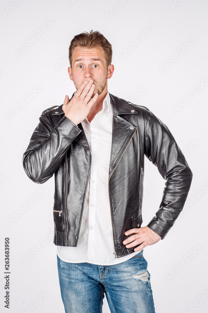portrait of young man in black eather jacket isolated on a white background. Emotion and people concept. portrait of young man in black eather jacket isolated on a white background. Emotion and people concept.