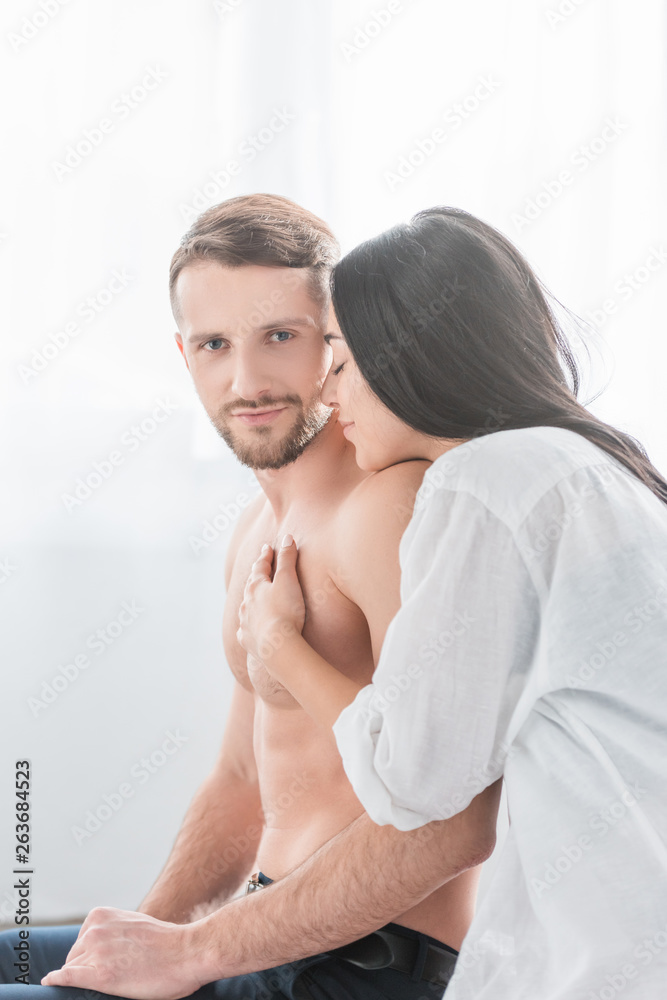 happy woman in white shirt hugging shirtless bearded boyfriend happy woman in white shirt hugging shirtless bearded boyfriend