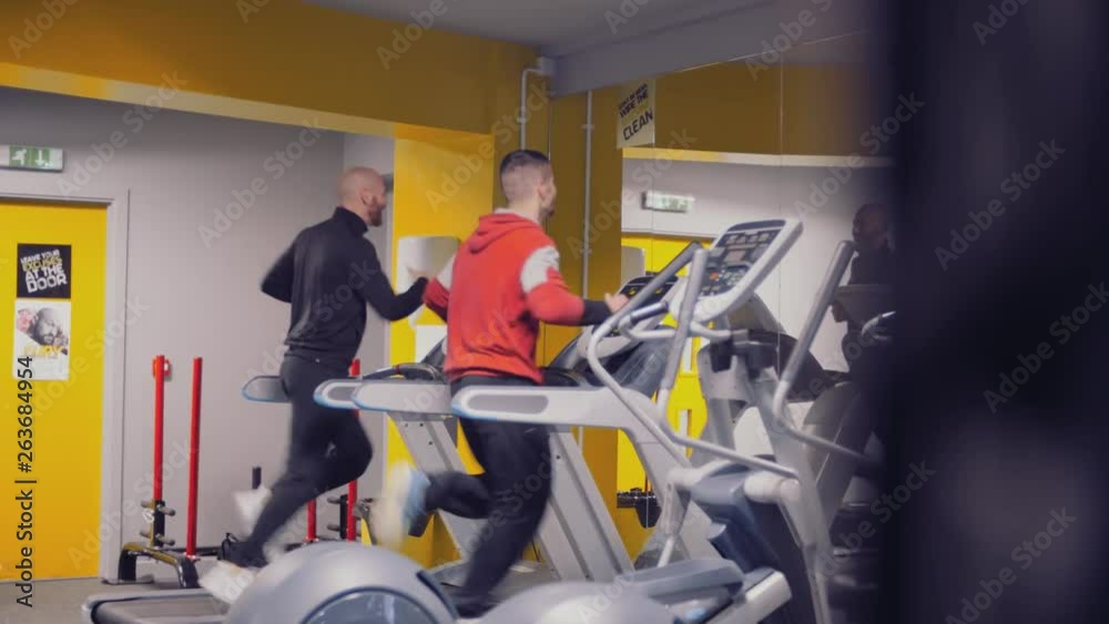 Personal trainer on treadmill with client