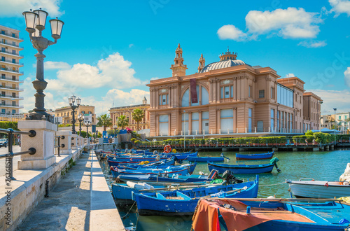 Docked boats with the Margherita Theatre in background, Bari, Apulia, southern Italy. photo