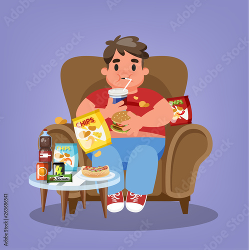 Fat man sitting in the armchair and eating fast food