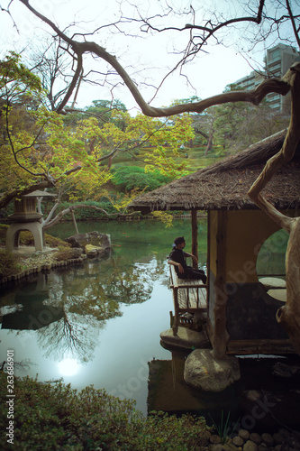 boy in a traditional japanese garden with lake, discover the world japan tokyo