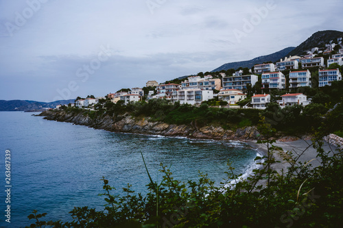 Cloudy coast landscape with houses and near the sea in Catalonia, Spain.