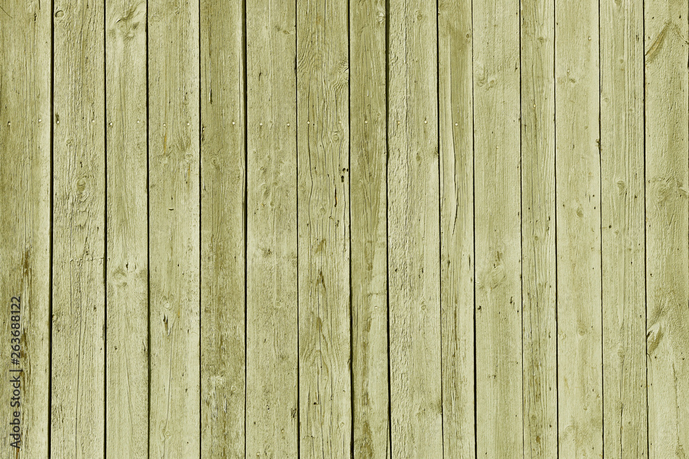 The texture of green from old wooden planks arranged in a vertical order. Background for further design. Ancient building material. Rough relief texture of natural wood. Combustible insulating surface