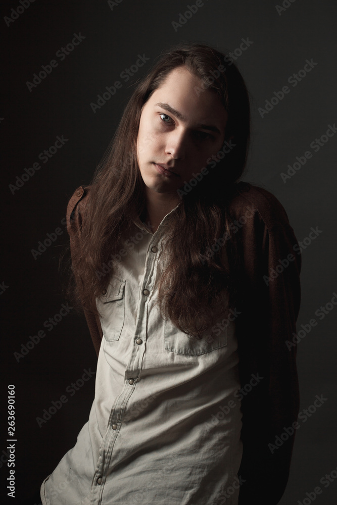 Portrait of handsome young man with long hair. Low key Portrait of handsome young man with long hair. Low key