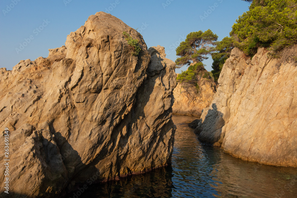 Cliffs in sea on Costa Brava coast, Spain. LLoret de Mar seascape. Sea rocky nature in spanish shore