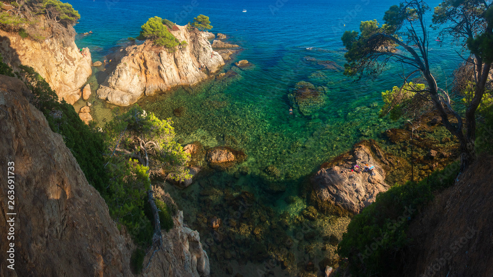 Lloret de Mar sea coast with cliffs in water