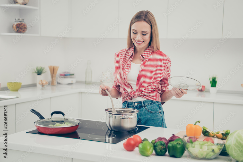 Close up photo beautiful amazing she her lady prepare delicious meal appetite mix all pan family favorite dish excited wear domestic home apparel shirt jeans denim outfit bright home kitchen indoors