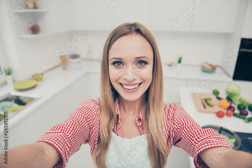 Close up photo beautiful she her lady preparations delicious meal dish make take selfies social cuisine blogger translation master class chief wear domestic apron shirt bright home kitchen indoors