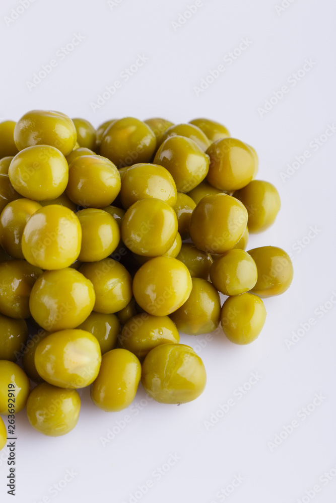 canned green peas on a white acrylic background canned green peas on a white acrylic background