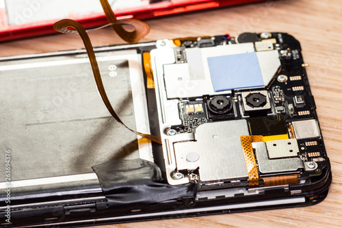 smartphone repair tools on wood table