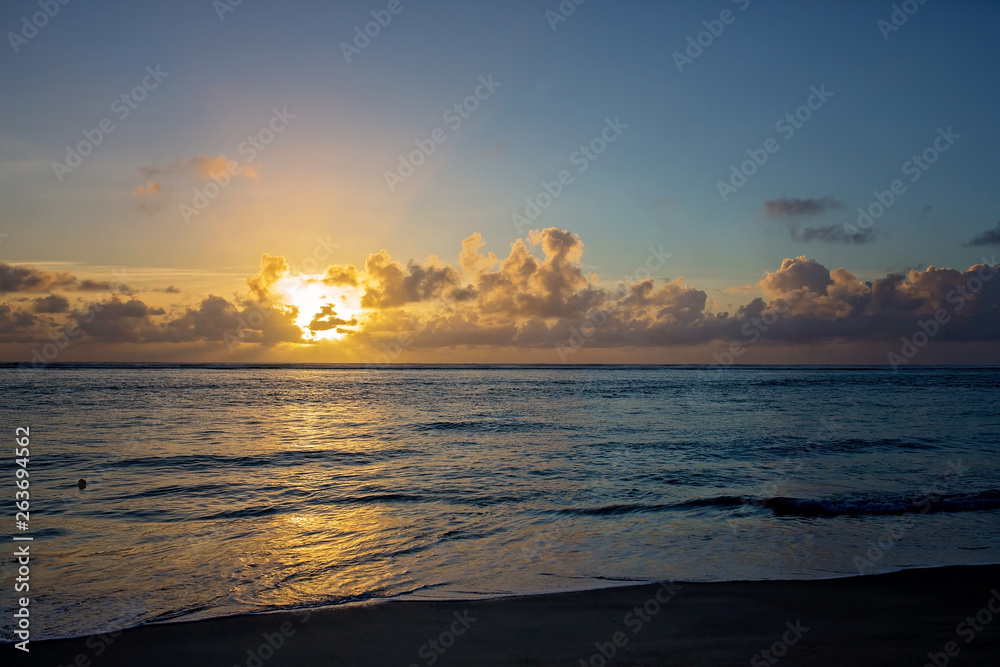 Fototapeta premium Luxury beach hotel, silhouette of palm trees, swimming pool, an beautiful sunrise