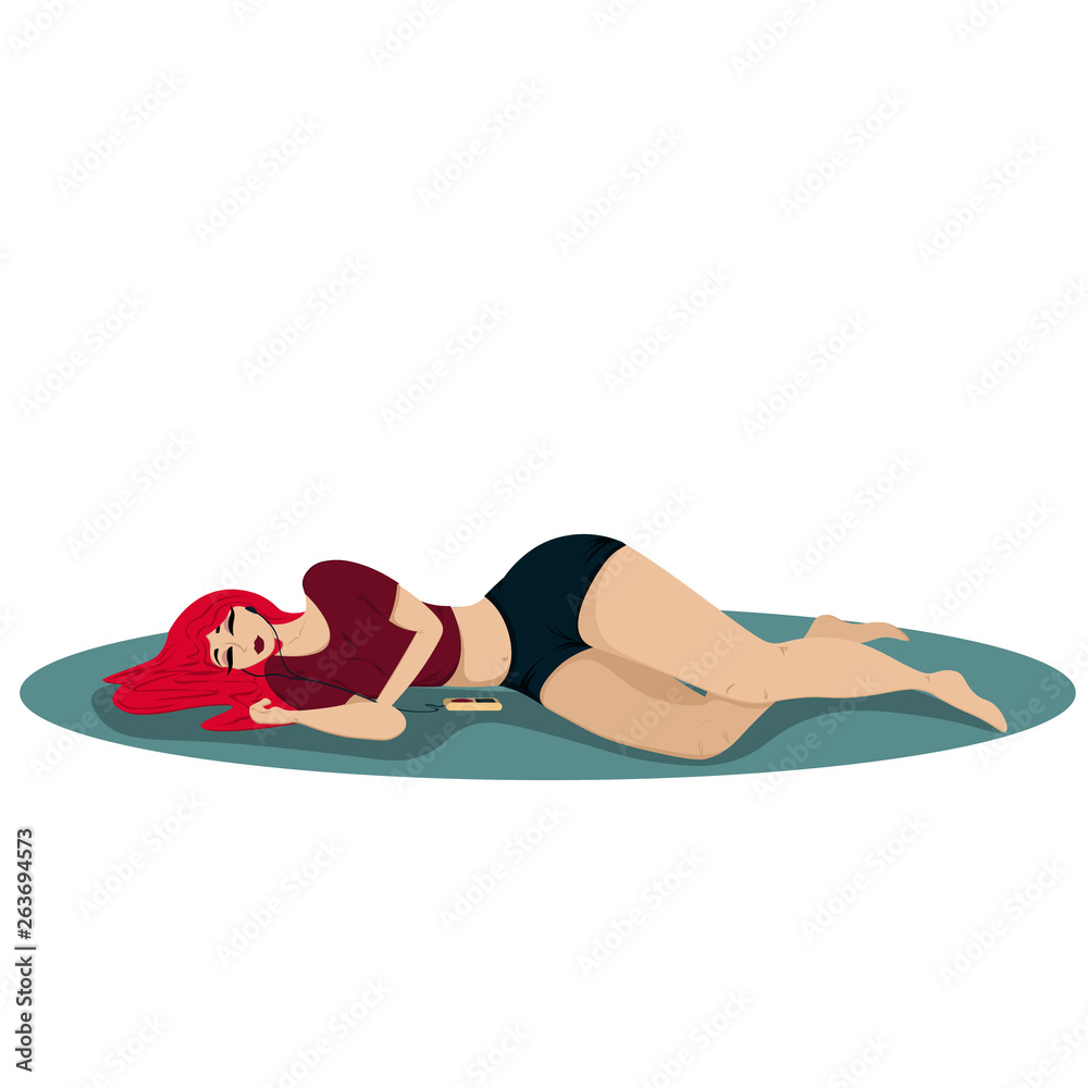 Young beautiful woman lies on the carpet and listens to music in the player Young beautiful woman lies on the carpet and listens to music in the player