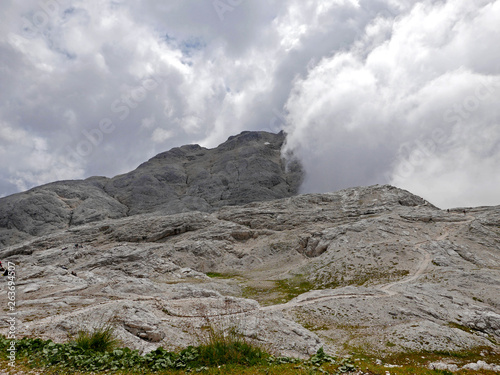 cima molto alta dolomitica immersa nella nebbia photo