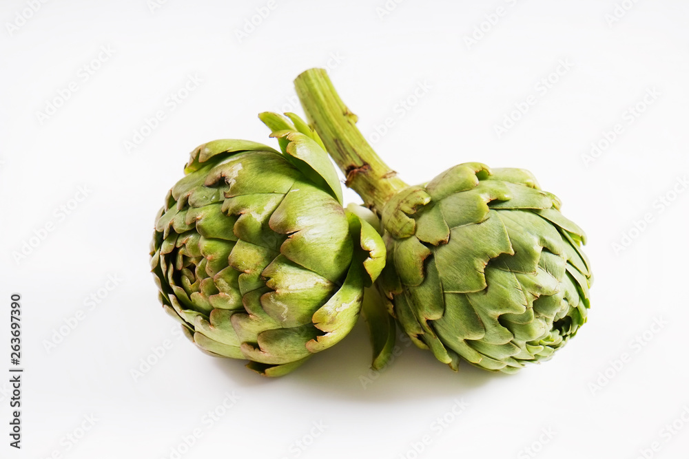 Obraz premium Fresh green Italian Artichoke isolated on white background. Organic local produce vegetable. Vegan diet. Clean eating concept. Close up, top view.