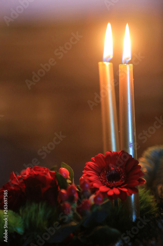 Cierges sur une couronne de fleurs. / Candles on a wreath. photo