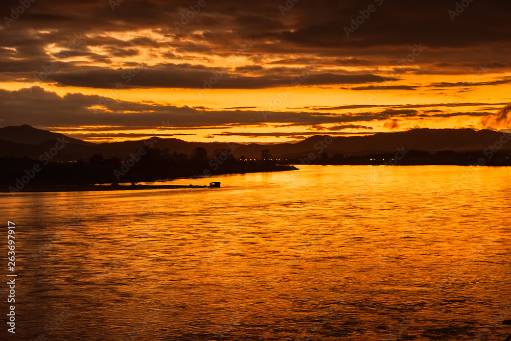 In the morning, the sun rises on the banks of the Mekong River in the Golden Triangle, Chiang Rai, Thailand. In the morning, the sun rises on the banks of the Mekong River in the Golden Triangle, Chiang Rai, Thailand.