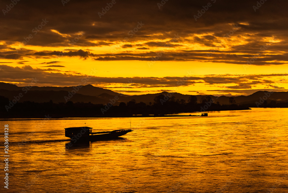 The ship is sailing in the Mekong River in In the morning, the sunrise in the Golden Triangle, Chiang Rai, Thailand