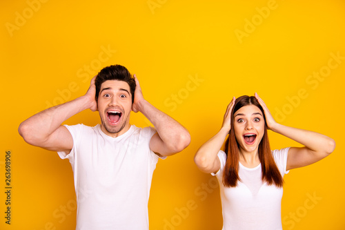 Close up photo two amazing beautiful she her he him his couple standing side by side oh yeah yes expression yelling unbelievable good news wear casual white t-shirts outfit isolated yellow background photo