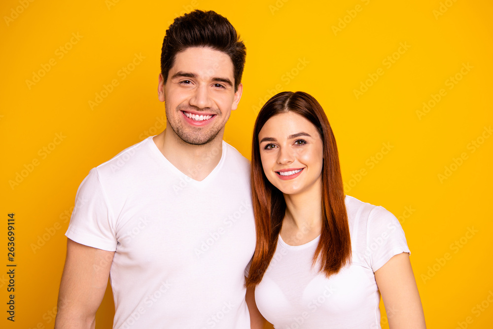 Close up photo funny amazing beautiful she her he him his guy lady standing hugging sincere beaming smile easy-going best fellows buddies wear casual white t-shirts outfit isolated yellow background Close up photo funny amazing beautiful she her he him his guy lady standing hugging sincere beaming smile easy-going best fellows buddies wear casual white t-shirts outfit isolated yellow background