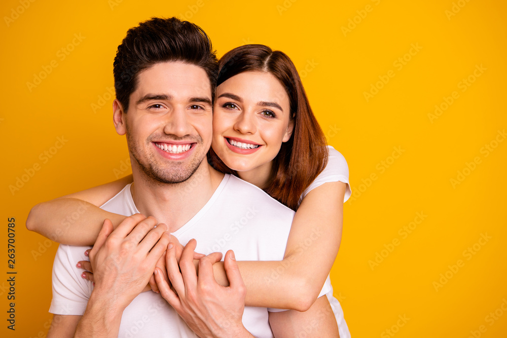 Close-up portrait of his he her she two nice cute lovely charming sweet tender attractive cheerful positive people cuddling isolated over vivid shine bright yellow background - obrazy, fototapety, plakaty 