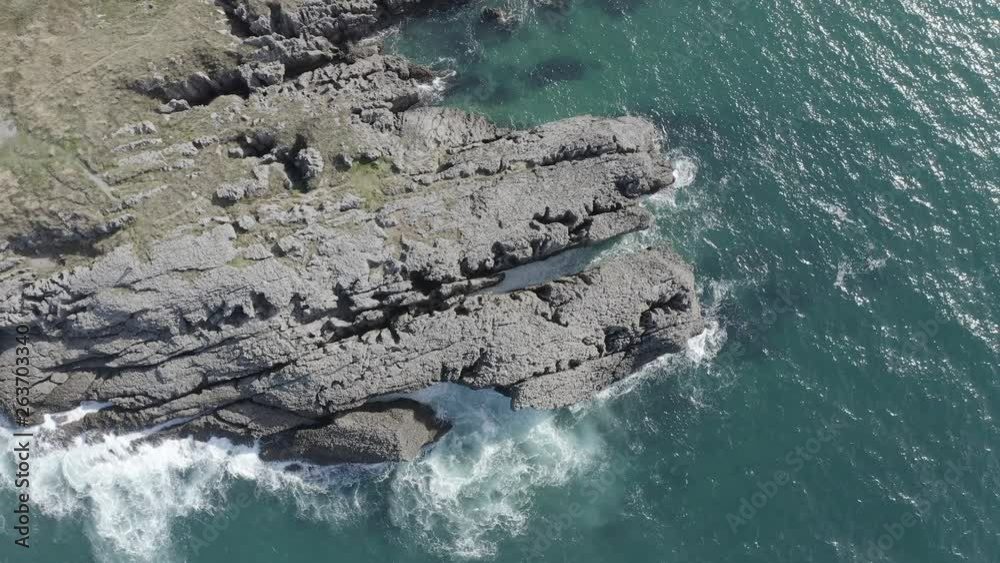 Sea waves breaking in the reefs of the coast in Sonabia #051, Spain, Cantabrian sea - drone aerial 4k footage ungraded (graded version available) Sea waves breaking in the reefs of the coast in Sonabia #051, Spain, Cantabrian sea - drone aerial 4k footage ungraded (graded version available)