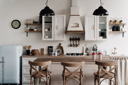 The interior of the bright kitchen with a bar in the Scandinavian style
